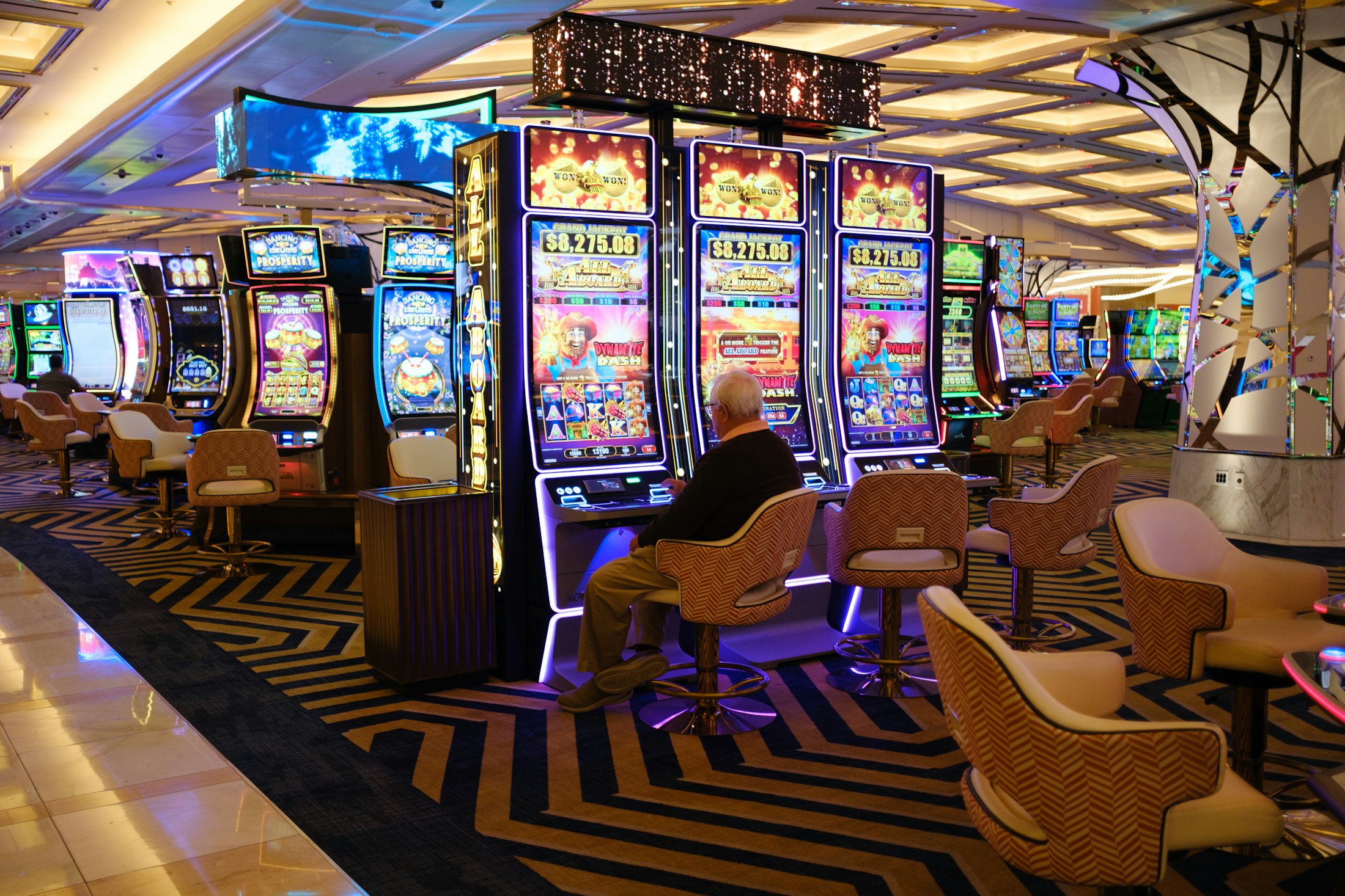 Rows of illuminated slot machines in a casino